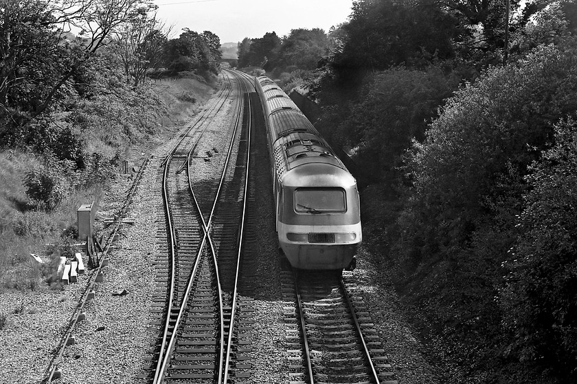 253019, unidentified down working, Bathampton ST769662 
 HST set 253019 approaches Bath from the east with an unidentified down working. The picture is taken from an occupation bridge near Bathampton that is in the distance behind the trees. The Bathampton loop is seen on the left that has been shortened a little; it used to extend a further under the bridge on which I am standing with the points opposite the closed Bathampton West signal box. This loop is still in use today now being passed by class 800 IETs that have recently replaced the HSTs. 
 Keywords: 253019 down working Bathampton ST769662