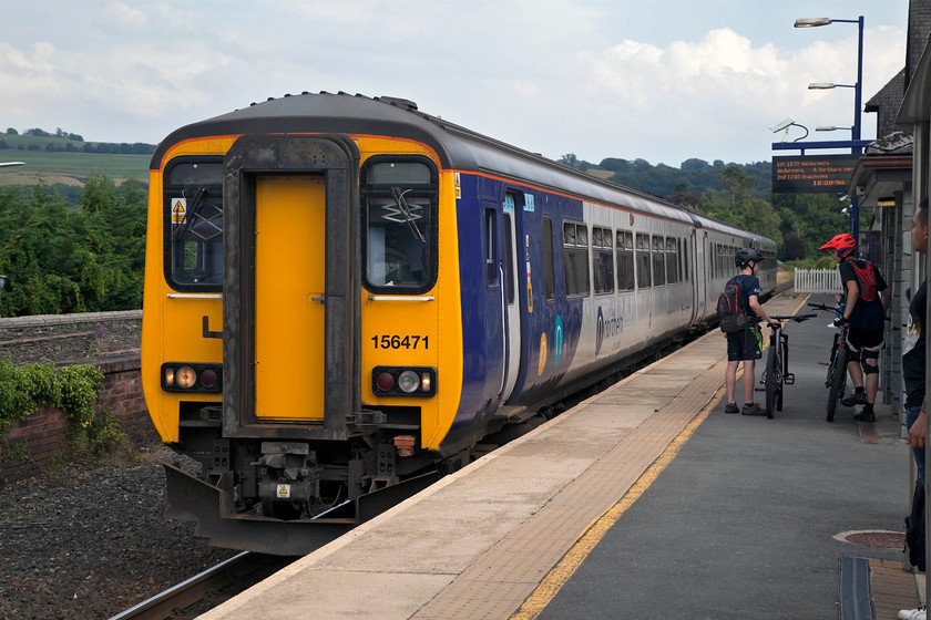 156471 & 153328, NT 16.24 Oxenholme Lake District-Windermere (2C28, 2L), Kendal station 
 With Northern having reinstated some its services on the Windermere Branch a couple of weeks earlier, 156471 and 153328 enter Kendal station forming the 16.24 Oxenholme to Windermere. As can be seen in this picture, the fine and sunny weather of the previous few days had given way to cloudy but very humid conditions. 
 Keywords: 156471 153328 2C28 Kendal station