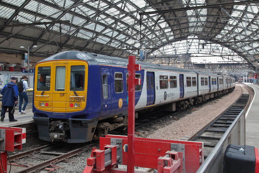 319376, NT 17.31 Liverpool LS-Preston (1N81, 1L), Liverpool Lime Street station 
 Northern 319376 sits under the grand and imposing train shed at Liverpool Lime Street. It was waiting to work the 1N81 17.31 to Preston via St. Helens. 
 Keywords: 319376 1N81 Liverpool Lime Street station