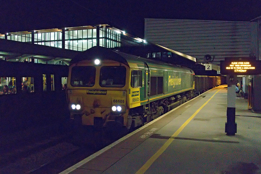 66605, 15.02 Bow Depot-Tunstead Sidings (6M81), Northampton station 
 An experiment that I never thought that I could pull-off! A train was signalled at Northampton station to pass straight through whilst we were waiting for our service to Rugby. I thought that I would bang the camera ISO up to a ridiculous number (10000) and see what could be produced. With the train moving I had to use at least 1/320th sec. so I am amazed with how it turned out. Admittedly, I did have to use an excellent piece of software called Neat Image to clean the picture up but you have got to be impressed by what modern camera technology and software can do! The image shows 66605 passing through Northampton with the 6M81 15.02 Bow Depot to Tunsted sidings empty stone train. 
 Keywords: 66605 15.02 Bow Depot-Tunstead Sidings 6M81 Northampton station