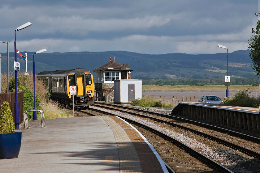 156452, NT 08.38 Preston-Carlisle, Arnside station 
 Andy and I arrived on to Arnside's down platform as the 08.38 Preston to Carlise Northern service was just departing. This is the reason why the rear of 156452 is partially obscured by the trespass sign. I did at least manage to capture the superbly situated Furness Railway Type 4 signal box dating from 1897 the Kent Estuary in the background. There is talk that this box is to join many others on this line and become a listed structure by Historic England. This will create another headache for Network Rail as to what to do with it when its use as a signal box coes to end that should be in the not to distant future. 
 Keywords: 156452 08.38 Preston-Carlisle Arnside station Northern