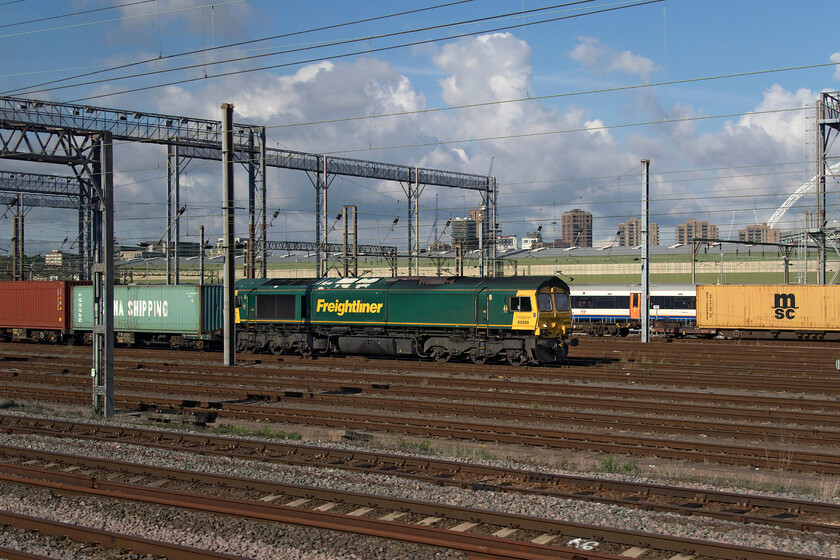 66589, an extended layover, Wembley Yard 
 With some dramatic clouds towering above North London, Wembley Yard manages to catch some strong September sunshine! 66589 is centre stage having been sitting at the head of the 4L52 Garston to London Gateway since the previous day. I am not sure if another 66 took the 4L52 to its destination and if 66589 is still attached to this working because the locomotive worked the 4L91 09.04 (Mo) Wembley Yard to Felixstowe the following morning. Thanks to my friend Mike for helping identify this rather complicated set of moves using his access to TOPS. 
 Keywords: 66589 an extended layover Wembley Yard Freightliner