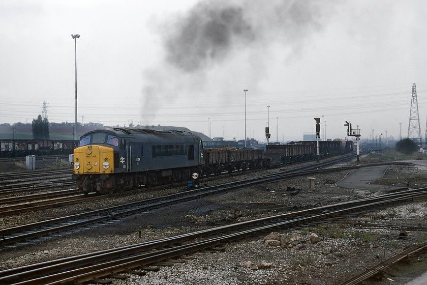 44004, down freight, Toton Yard 
 I had been at Toton for some time now and having seen no class 44s I was getting concerned. By late 1979 there was only three left in service so my chances were limited. This was all about to change as 44004 (ex D4, Great Gable) arrived with a down freight that included some delightfully antiquated wagons. With a characteristic plume of exhaust from its Sulzer engine, it gets underway off to the north yard. 
 Keywords: 44004 down freight Toton Yard