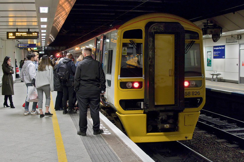 158826, AW 20.09 Birmingham International-Machynlleth (1J31, 1E), Birmingham New Street station 
 It's a shame that there were so many passengers in the way and that I was in the gloom of Birmingham New Street station as I really wanted a picture of 158826 in its new and very smart Transport for Wales/Gwaith Trafnidiaeth Cymru livery. The class 158 is pausing working the 20.09 Birmingham International to Machynlleth service that was full and standing here at New Street. It seems to have slipped under the radar a bit but we now have two state owned and operated railway companies. On the East Coast, LNER is doing an excellent job, and now in Wales, let's hope that the Welsh Government can do the same with their railway network. 
 Keywords: 158826 20.09 Birmingham International-Machynlleth 1J31 Birmingham New Street station