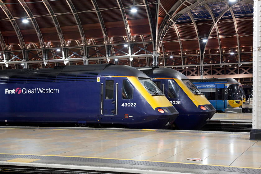 43022, GW 23.30 London Paddington-Cardiff Central (1C36, 9L), 43026, GW 22.15 London Paddington-Bristol Temple Meads (1C33, RT) & class 332s, London Paddington station 
 The modern lighting at Paddington has given it a whole new atmosphere at night with it being bright and not causing the colour balance of the camera to take on a hue that needs adjustment. Sitting at the blocks are two HSTs, 43022 'The Duke of Edinburgh's Award Diamond Anniversary 1956-2016' and 43026 'Michael Eavis' and two Gatwick Express class 332s. Both these power cars were early Western Region deliveries in 1976, being parts of sets 253011 and 253013 respectively. This is a scene set to change next year with the introduction of the IETs and these veterans of the GWML will bow out after years of service unless another use can be found for them? 
 Keywords: 43022 1C36 43026 1C33 class 332s London Paddington station