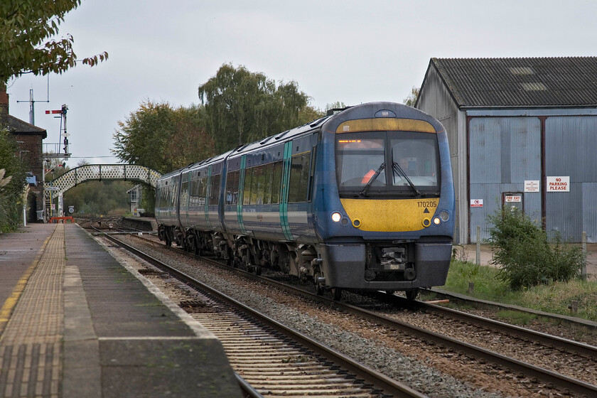 170205, LE 13.00 Lowestoft-Norwich, Brundall station 
 170205 passes through Brundall station working Greater Anglia's 13.00 Lowestoft to Norwich service. It appears that I am trespassing off the end of the platform but, unusually, public access to this platform is via a footpath from the village directly on to the ramp. 
 Keywords: 170205 13.00 Lowestoft-Norwich Brundall station