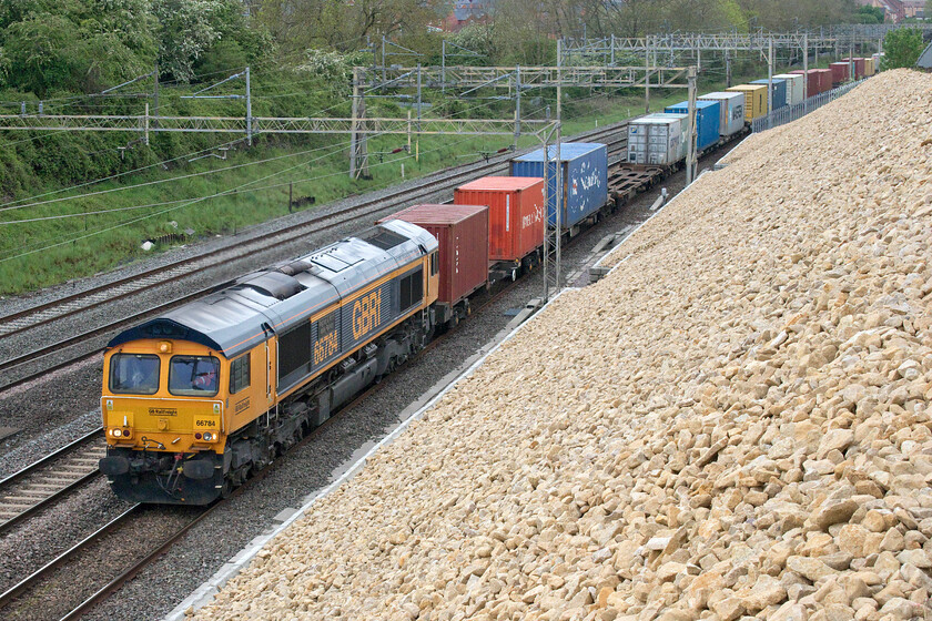 66784, 08.00 Birch Coppice-Felixstowe N (4L29, 4L), Ashton Road bridge 
 66784 'Keighley & Worth Valley Railway 50th Anniversary 1968-2018' leads the 4L29 08.00 Birch Coppice to Felixstowe past Roade. This freight working can be routed one of two ways either using the WCML as seen here or via the former Midland route to Peterborough via Leicester. 
 Keywords: 66784 08.00 Birch Coppice-Felixstowe N 4L29 Ashton Road bridge Keighley & Worth Valley Railway 50th Anniversary 1968-2018