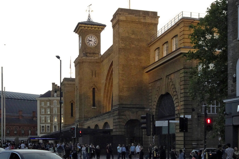 Frontage, London King's Cross station 
 Just catching some evening sunshine the frontage of King's Cross station looks grand standing above the busy roads surrounding it. The superb Lewis Cubitt-designed station is now fully revealed following its extensive redevelopment completed in 2012. The area in front of the station is now a large paved open space that sees a range of uses for example a regular food fare. 
 Keywords: Frontage London King's Cross station