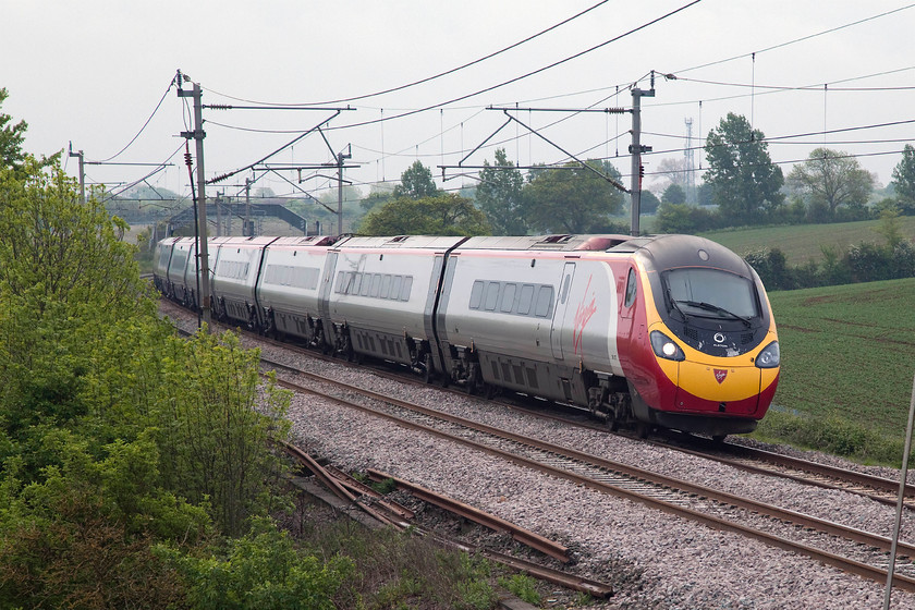 390127, VT 07.20 London Euston-Manchester Piccadilly (1H09, 1L), Blisworth 
 390127 'Virgin Enterprise' heads north past Blisworth on the Weedon loop just north of Roade Cutting with the 07.20 Euston to Manchester Piccadilly. 
 Keywords: 390127 1H09 Blisworth