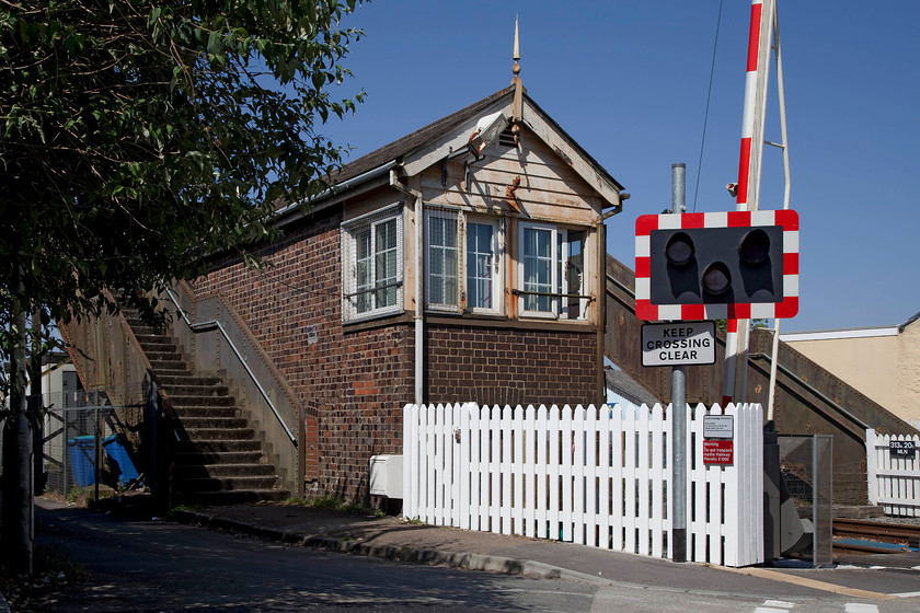 Roskear Junction signal box (GWR, c.1895) 
 The rear of Roskear Junction signal box in the Cornish town of Camborne. The box is situated at a level crossing just west of the point where the short brach to the Roskear mines diverged to the north of the line. This branch was shortened when the mines closed and continued to serve the Holmans boiler factory with the remaining stub finally shut by BR in 1987. 
 Keywords: Roskear Junction signal box