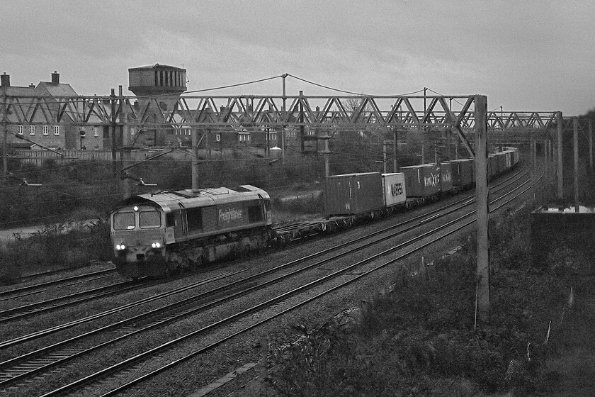 66518, 04.39 London Gateway-Lawley Street (4M56, 2E), site of Roade station 
 With the light so dire I thought that I would convert to greyscale in an attempt to to record the passing of the 4M56 04.39 London Gateway to Lawley Street Freightliner. With its headlights glowing in the gloom of a wet and cold Saturday morning the train is seen passing Roade. 
 Keywords: 66518 04.39 London Gateway-Lawley Street 4M56 site of Roade station Freightliner