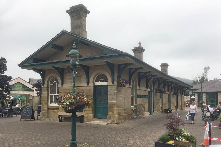 Former Rowsley station, now part of Peak Shopping Village 
 The Peak Shopping Village is an outlet centre situated between Bakewell and Matlock in the Peak District. It is largely built on land that used to be occupied by the Midland Railway's goods yard, land on which the old station building, seen here, is located. It was once the terminus of the Midland route up from Matlock and the south and was constructed in 1849. It became redundant in 1862 when the line was extended to Bakewell and beyond via a chord to the south of this site. It lingered on as rail connected goods depot for many years and then lost its railway link when British Railways closed the entire Midland route through the Peak District in 1968. It was awarded Grade II listed status in 1972 so the building remained whilst all around was developed. It is now an integral part of the Peak Shopping Village with various smaller outlets using the building so its future is secure for the moment anyway. 
 Keywords: Former Rowsley station Peak Shopping Village