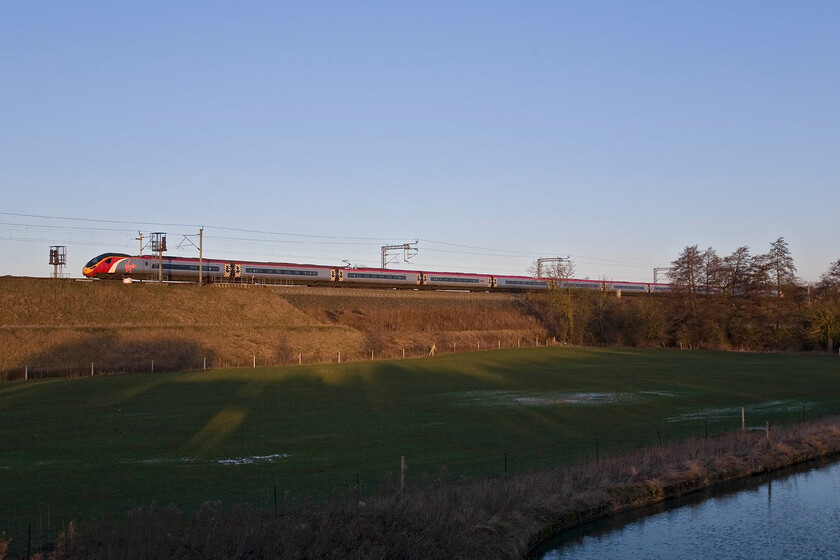 Class 390, VT 07.30 London Euston-Glasgow Central, Whilton Locks SP619640 
 The 07.30 Euston to Glasgow Central Anglo-Scottish Virgin West Coast service runs near the Grand Union Canal in rural Northamptonshire. Whilst the bucolic scene appears quiet looks can be deceiving with the M1 motorway just a few hundred metres behind where I am standing. 
 Keywords: Class 390 07.30 London Euston-Glasgow Central Whilton Locks SP619640 Virgin Pendolino