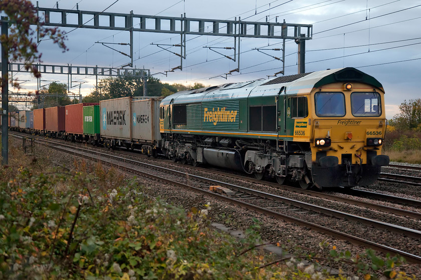 66536, 04.25 Felixstowe North-Lawley Street (4M88), Ashton Road bridge 
 66 536 leads the 04.25 Felixstowe North to Lawley Street 4M88 Freightliner on the southern WCML between Ashton and Roade. I was pushing the camera's ISO a little as it was a pretty dismal morning with a very strange warm red light on the back of Storm Callum that had passed the previous night causing some issues in the west of the country. 
 Keywords: 66536 04.25 Felixstowe North-Lawley Street 4M88 Ashton Road bridge