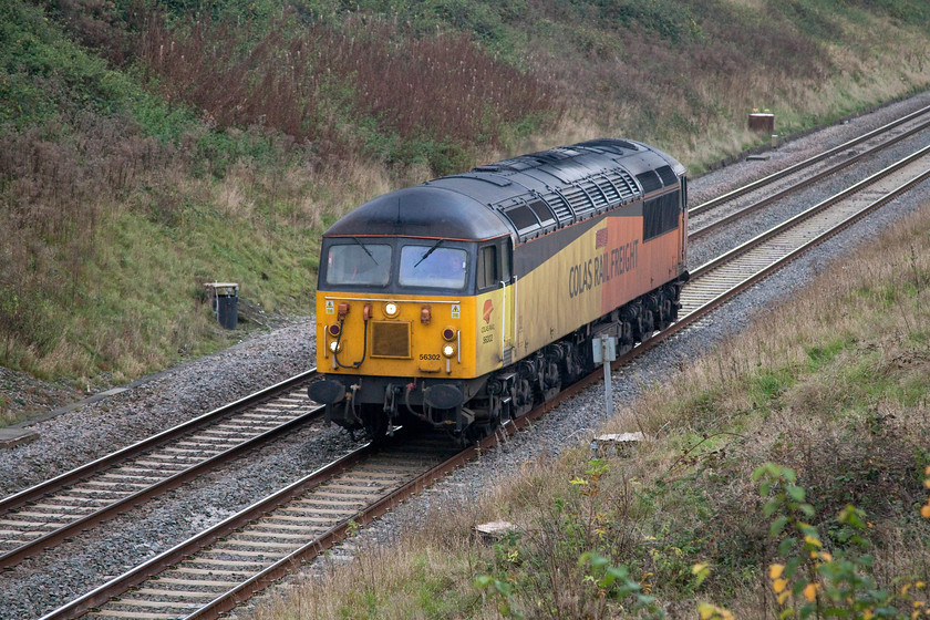 56302, 13.05 Gloucester Horton Road-Washwood Heath (0Z56), Bourton SU234875 
 I had seen some gen that this mysterious light engine movement was taking place along the GWML and that it was coinciding with my drive home from Box so I decided to wait and see what it produced. Colas 56302 'Peco The Rail Modeller 2016 70 Years' runs as the 13.05 Gloucester Horton Road to Washwood Heath. I never did discover why this light engine move went via the circuitous route from Gloucester to Birmingham via Didcot and Banbury. It is seen passing Bourton just east of Swindon. 
 Keywords: 56302 13.05 Gloucester Horton Road-Washwood Heath 0Z56 Bourton SU234875