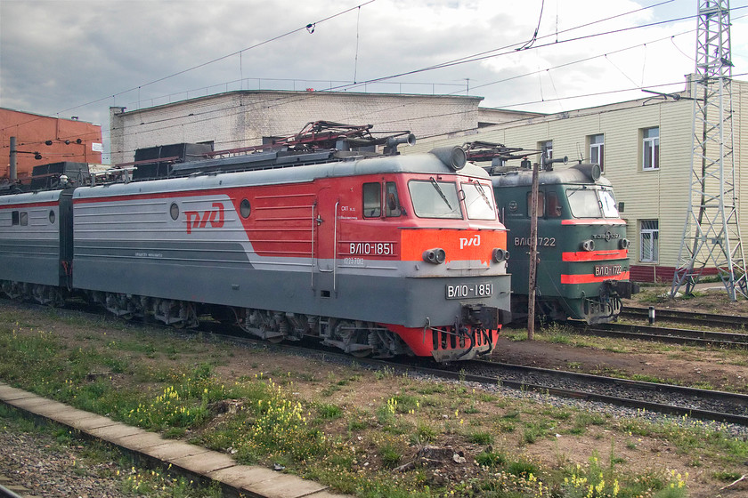 VL10-1851 & VL10-1722, stabled, Tver station 
 On the final approach to Tver station, there were a number of stabled electric locomotives. Probably the most interesting was this pair of VL10s dating from the 1960s. VL10-1722 is in its traditional Soviet-era green livery and looks every bit its age but for the removal of the red star from the nose. VL10-1851 looks slightly less dated in its revised RZD livery. These articulated locomotives were constructed at the Tbilisi locomotive works with a final batch at the Novocherkassk electric locomotive factory. Their class, NV, is named after the USSR's founding father, Vladimir Lenin. 
 Keywords: VL10-1851 VL10-1722 stabled Tver station