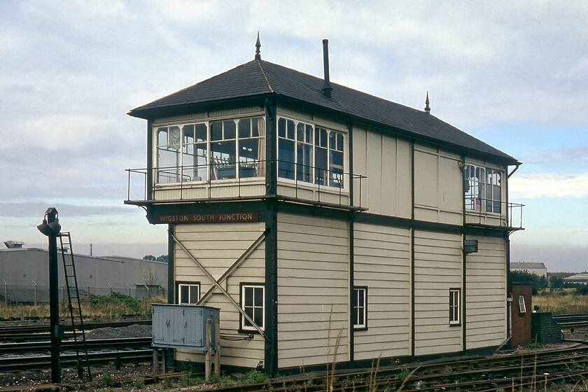 Wigston South Junction signal box (MR, 1900) 
 Taken from the rear Wigston South Junction signal box is seen with its British Railways London Midland Region maroon enamel nameplate which was fitted in the spring of 1961. The box is a Midland Type 3b design that was constructed in 1900 when this section of the Midland Mainline was quadrupled. It contained a sixty-lever London Midland Region standard frame that replaced the original Midland frame in the 1950s. The box closed on 29.06.86 when signalling between Market Harborough and Syston passed to the new Leicester power box. The structure was demolished plank by plank and piece by piece at the start of August 1986. 
 Keywords: Wigston South Junction signal box MR Midland Railway