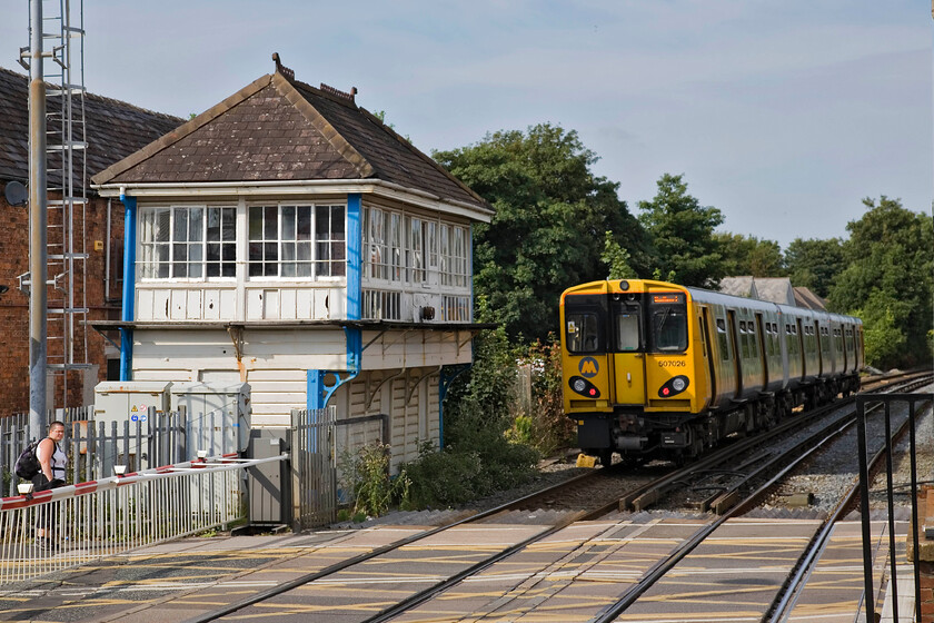 507026, ME 16.06 Hunts Cross-Soutport, Birkdale station 
 At last, the evening sun has come out again! The 16.06 Hunts Cross to Southport Merseyrail service leaves Birkdale station worked by 507026. It is passing the long-closed (nineteen years) 1905 Lancashire and Yorkshire signal box that looks a little in need of some care and attention from Network Rail. 
 Keywords: 507026 16.06 Hunts Cross-Southport Birkdale station Merseyrail