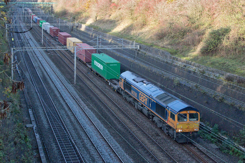 66765, 12.44 Hams Hall-Felixstowe N (4L21, 74L), Roade cutting 
 Cop number two..... 66765 leads the very late running 12.44 Hams Hall to Felixstowe through Roade cutting. To my surprise, this was my second photographic cop of the day and within fifteen minutes of seeing the last one! Although, like that image of GBRf's 66768, this one is also in the deep afternoon shade of Roade cutting but a cop is a cop! 
 Keywords: 66765 12.44 Hams Hall-Felixstowe N 4L21 Roade cutting GBRF