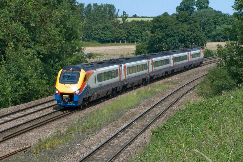 222013, EM 10.05 Nottingham-London St. Pancras (1B31), Finedon Road industrial estate SP900702 
 222013 working the 1B31 10.05 Nottingham to St. Pancras 'fast' service approaches Wellingborough at speed. Unfortunately, the angle of the strong summer sun has just moved round such that it not quite illuminating the side of the train at this location. 
 Keywords: 222013 10.05 Nottingham-London St. Pancras 1B31 Finedon Road industrial estate SP900702 EMR East Midlands Railway Meridian