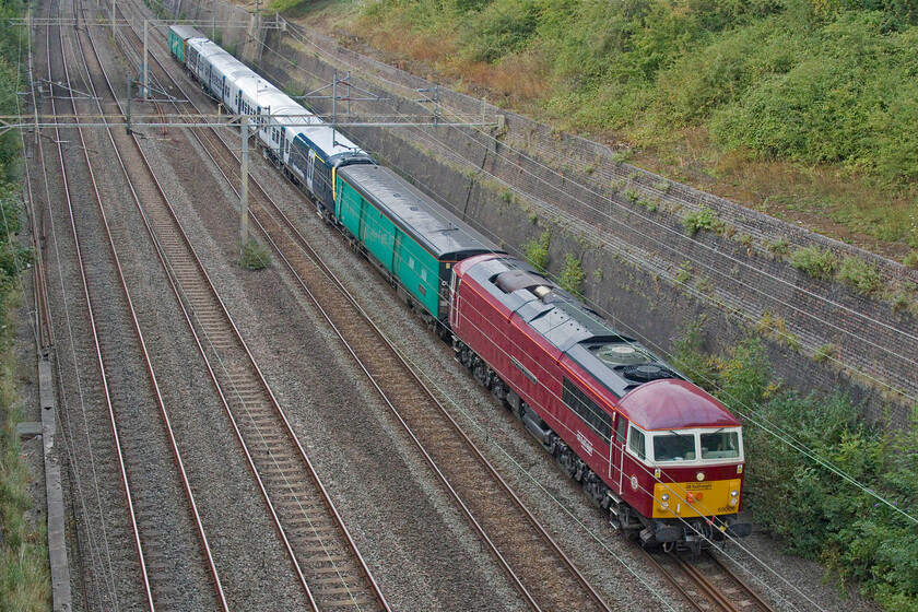 69009 & 458418, 13.11 Widness Transport Tech-Wembley Yard (5Q62, 53E), Roade cutting 
 The second Class 69 to pass through Roade cutting in half an hour. 69009 'Western Consort' (formally 56060) leads SWR's 458418 and a pair of barrier coaches as the 5Q62 13.11 Widness Transport Tech to Wembley Yard. The unit has been undergoing an overhaul and extended in length by one carriage to then work the Waterloo to Portsmouth 'fast' services. There have been a number of these moves over the past year or so with various locomotives tasked with hauling them, for example, see... https://www.ontheupfast.com/p/21936chg/30037057483/x50007-458505-50049-11-22-clapham 
 Keywords: 69009 458418 13.11 Widness Transport Tech-Wembley Yard 5Q62 Roade cutting western consort