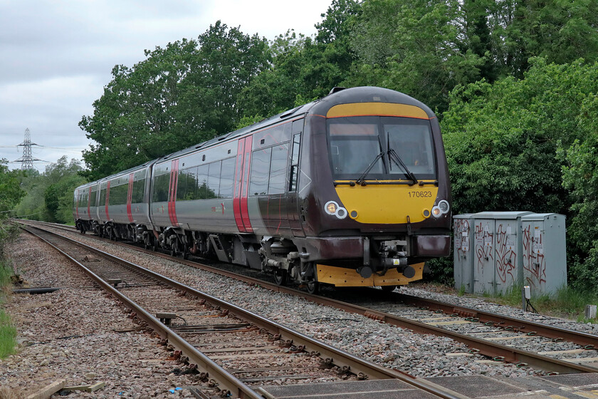 170623, XC 10.22 Birmingham New Street-Stansted Airport (1L36, 1E), Bainton Green level crossing 
 The 10.22 Birmingham New Street to Stansted Airport CrossCountry service approaches Helpston Junction crossing Bainton Green level crossing. The train is being worked by Turbo unit 170623 one of twenty-two three-car sets operated by CrossCountry. Andy and I both commented on how little time there was at this level crossing from when the piezo sounders started, the ahb went down and the train arrived at some speed. This was in stark contrast to the situation at Lolham level crossing just a third of a mile along the lane where the barriers protecting the ECML seemed to go down very early. 
 Keywords: 170623 10.22 Birmingham New Street-Stansted Airport 1L36 Bainton Green level crossing CrossCountry Turbo