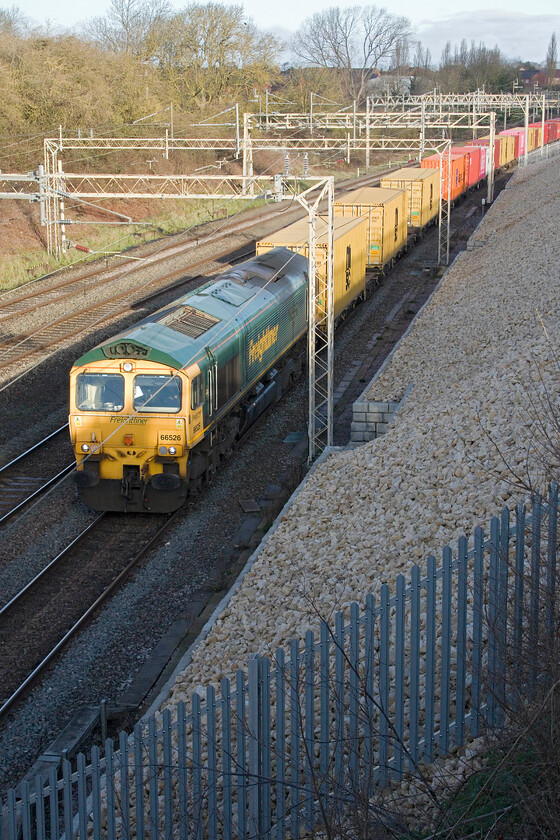 66526, 03.25 Garston-London Gateway (4L52, RT), Ashton Road bridge 
 Half catching some early morning sunshine that has escaped through some fast-moving cloud 66526 Driver Steve Dunn (George) leads the 03.25 Garston to London Gateway Freightliner service. On this Saturday morning, the 4L52 was well loaded and fairly long with me unable to capture the rear of the train in this view partly due to my poor composition! 
 Keywords: 66526 03.25 Garston-London Gateway 4L52 Ashton Road bridge Driver Steve Dunn (George) Freightliner