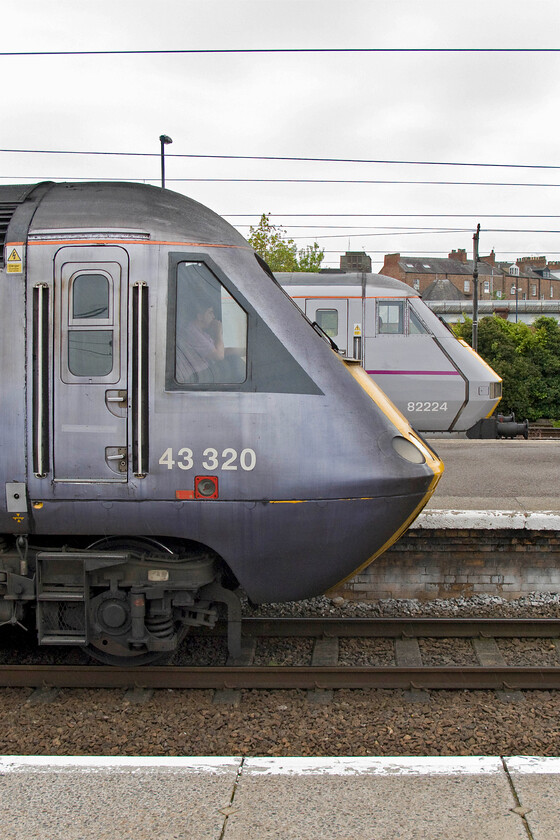 43320, GR 16.01 York-London King's Cross (1Y38) & 82224, GR 13.30 Edinburgh Waverley-London King's Cross (1E17), York station 
 Two versions of the same operators grey livery one slightly older than the other. In the foreground is the metallic grey/blue livery as applied by the highly unpopular National Express East Coast after it took over from GNER in December 2007. It is being carried by HST power car 43320. This power car, as 43120 along with 43121, were designated as 'spares' when delivered to the Eastern Region in November 1977 with neither assigned to a 254 set. In the background, wearing East Coast's proper 'grey' livery, is DVT 82224. Whilst the HST will leave York leading the 16.01 service to King's Cross the DVT will leave first with the 13.30 Edingburgh to King's Cross. 
 Keywords: 43320 16.01 York-London King's Cross 1Y38 82224 13.30 Edinburgh Waverley-London King's Cross 1E17 York station East Coast HST InterCity Class 225