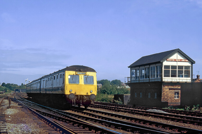 Class 120 DMU, 11.37 Leicester-Birmingham New Street, Knighton South Junction 
 A three-car Class 120 DMU gets into its stride as it leaves Leicester passing Knighton South Junction working the 11.37 Leicester to Birmingham New Street service. The Midland Region had a relatively small allocation of these handsome Swindon-built units based at Etches Park that were used on various routes. The short five-chain Knighton tunnel can be seen in the background as can the 1936 LMS Knighton South Junction signal box. The line branching off to the left leads to Stenson Junction via Coalville which is still in use today as a freight-only route. 
 Keywords: Class 120 DMU 11.37 Leicester-Birmingham New Street Knighton South Junction Swindon first generation DMU