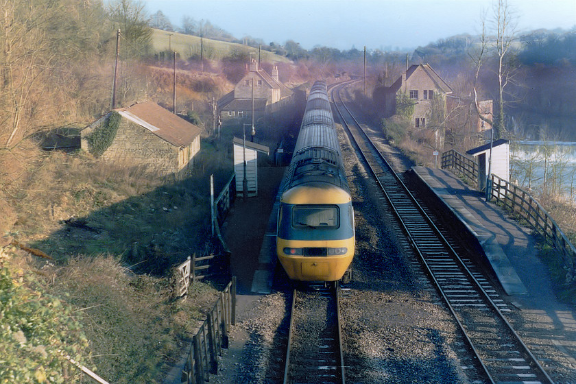 43121, 11.00 Weston-super-Mare-London Paddington, Avoncliff station 
 Diversions through the Avon Valley were pretty frequent when engineering works closed the GWML. This was the case here at Avoncliff with a class 43 HST passing the diminutive halt with the 11.00 Weston-super-mare to Paddington. HST guru Kevin Daniel is pretty sure that this power car is 43121. This is because it was one of only two that did not carry set numbers the other one being 43120. As 43120 was receiving a 'B' exam. at St. Philips Marsh on this particular Sunday that only leaves 43121 on this service. Depending on the nature of the diversion, the HST could have taken one of two routes when it reached Bradford Junction, some five miles from here. It could take the now lifted north chord and travel via Melksham back to the GWML at Thingley Junction or, alternatively, it could go further to Westbury and take the little used chord from Blatchbridge to Heywood Junction and then proceed to London along the Berks. and Hants. route. In this image, the River Avon can be seen to the right with the old mill and the weir. Notice the mist hanging around in the valley on this chilly early afternoon. 
 Keywords: 4312 11.00 Weston-super-Mare-London Paddington Avoncliff station