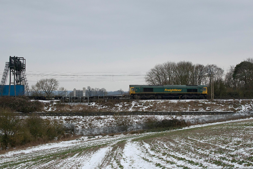 66538, 07.50 Felixstowe North-Lawley Street (4M94), Roade Hill 
 Whilst walking from home to Victoria bridge I captured 66538 leading the 4M94 07.50 Felixstowe North to Lawley Street Freightliner. It is seen heading north along the down slow between Roade and Ashton on the southern WCML. Whilst a lot of last night's snowfall had melted away, the scene is still suitably wintery! 
 Keywords: 66538 07.50 Felixstowe North-Lawley Street 4M94 Roade Hill