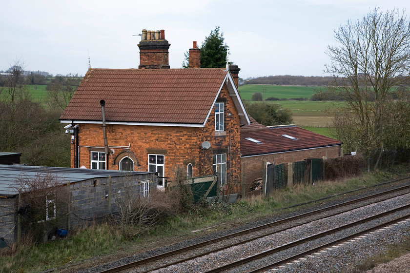 Former Isham & Burton Latimer station building (C. 20.11.1950) 
 The buildings of the former Isham and Burton Latimer station ars still standing and very much in use but as a private residence. The station was opened by the Midland Railway in 1857. Initially, it was just named Isham becoming Isham and Burton Latimer two years later in 1859. In 1923 it was again renamed, this time becoming Buton Latimer for Isham. These changes reflect its central location between the two villages just south of Kettering on the Midland Mainline and the battle between them as to which one was dominant! The station was closed by British Railways 01.10.50. 
 Keywords: Former Isham & Burton Latimer station building