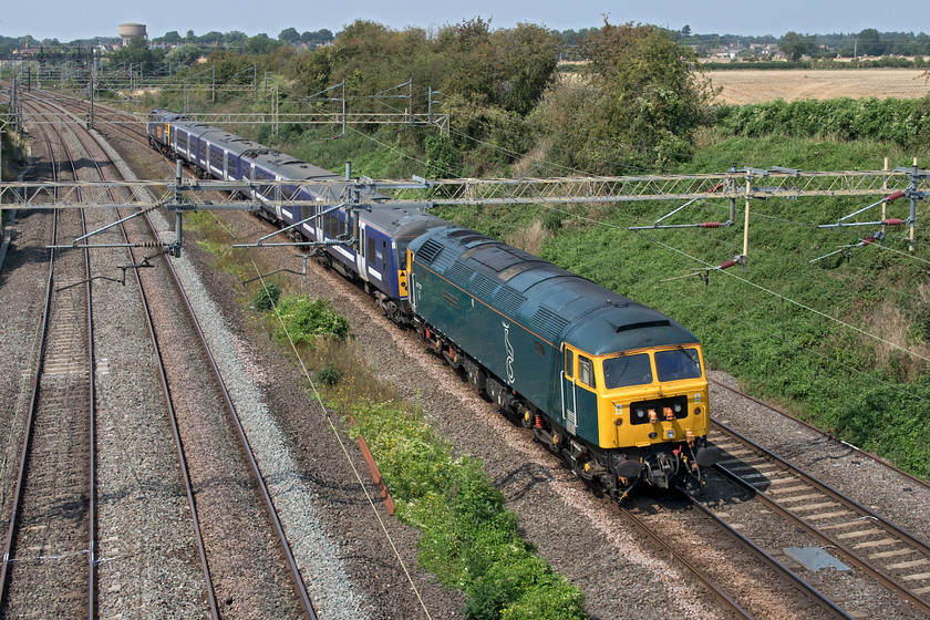 47727, 360112 & 47739, 11.22 Ilford EMUD-Northampton EMD (5Q60, 41E), Victoria bridge 
 47727 'Edinburgh Castle/Caisteal Dhun Eideann' brings up the rear of the 5Q60 11.22 Ilford EMUD to Northampton EMD past Victoria bridge between Roade and Ashton. Sandwiched in between 47727 and 47739 (leading) is 360112 being taken to Siemens Kingsheath depot for modifications to be undertaken. The train was running over forty minutes early having missed out a strange pathing allowance at Bletchley and by the time it reached me here, it was travelling very slowly. 
 Keywords: 47727 360112 47739 11.22 Ilford EMUD-Northampton EMD 5Q60 Victoria bridge CS GBRf Edinburgh Castle Caisteal Dhun Eideann