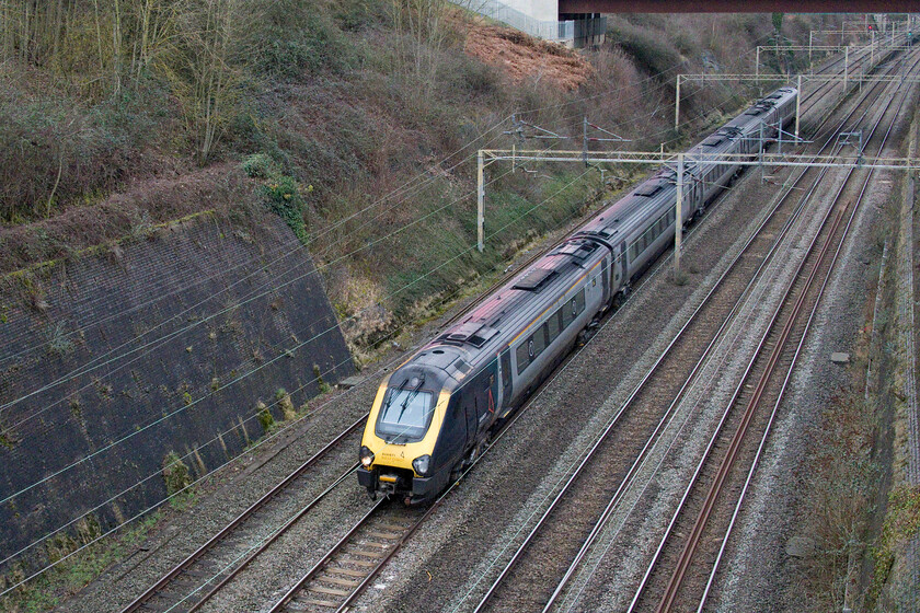 221113, VT 09.38 Holyhead-London Euston (1A23, RT), Roade cutting 
 The sound of Cummins QSK19-R engines STILL resonates around Roade cutting over a year after the Voyagers were due to be retired from the WCML and returned to Beacon Rail. The late introduction to service of the Class 805 and 807s has resulted in this extension; an all too common situation on our railways. 221113 heads south through the cutting working the 09.38 Holyhead to Euston. 
 Keywords: 221113 09.38 Holyhead-London Euston 1A23 Roade cutting AWC Avanti West Coast Voyager