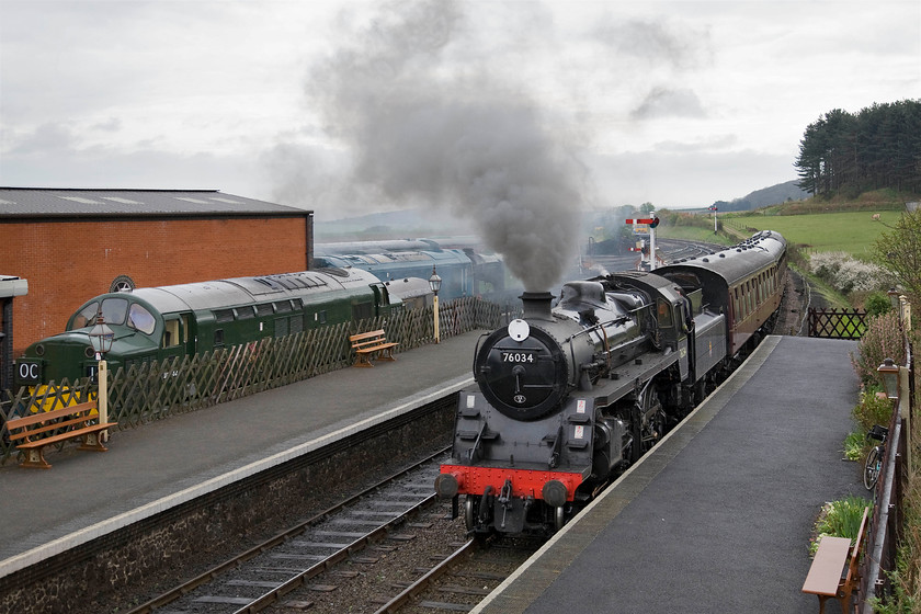 76034 (76084), 10.15 Sheringham-Holt, Weybourne station 
 British Railways Standard Class 4MT number 76084 masquerading as 76034 arrives at Welybourne with the 10.15 Sheringham to Holt train. This locomotive returned to service just last year (2013) after a protracted restoration that took sixteen years and cost an eye-watering 750 000! There is talk of it being returned to the mainline but further heavy costs will be incurred for all the necessary equipment if this is the case. Note the very smart looking English Electric Type 3 D6732 in the bay platform, that has also been in receipt of a recent restoration. 
 Keywords: 76034 10.15 Sheringham-Holt Weybourne station NNR North Norfolk Railway Poppy Line British Railways Standard Class 4MT 76084