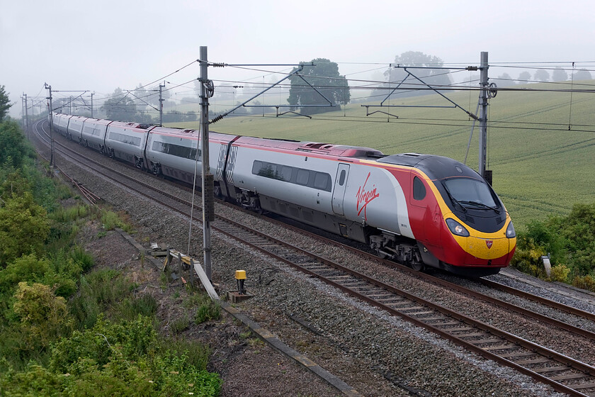 390013, VT 07.30 London Euston-Glasgow Central (1S42), Blisworth SP735539 
 390013 'Virgin Spirit' works the first down Anglo-Scottish express of the day past Blisworth on the Weedon loop line that avoids a slow journey via Northampton. The 1S42 07.30 Euston to Glasgow Central arrives at its destination at midday. 
 Keywords: 390013 07.30 London Euston-Glasgow Central 1S42 Blisworth SP735539 Virgin Pendolino Virgin Spirit