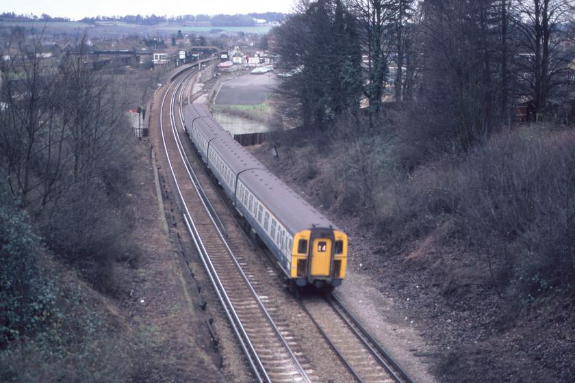 EMU, 11.49 Three Bridges-London Victoria, Merstham-29.12.80 
 What I believe to be a 4Cig unit passes Merstham with the 11.49 Three Bridges to London Victoria semi-fast working displaying the correct 44 Southern Region headcode. The rear coach of the four-car set is just crossing the M25 motorway deep in the concrete cutting. I am standing on Rockshaw Road bridge over which the Pilgrims' Way long-distance footpath crosses that my Venture Scout patrol group were following. Quite how I persuaded my patrol group to stand and wait for a train is a surprise, but perhaps it was a coincidence? 
 Keywords: 4Cig EMU, 11.49 Three Bridges-London Victoria, Merstham TQ291537