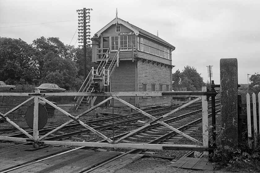 Ulceby Junction signal box (GC, 1910) 
 The rather grand looking Ulceby Junction signal box contained a thirty lever frame (a little small for the size of the structure perhaps?) and was built by the Great Central in 1910 following their development and opening of the nearby Immingham docks. In this view, the wooden manual gates that protected the A1077 road are seen along with the impressive telegraph pole that supports fifty porcelain insulators! When I visited again in 2007 the box was still in use and remarkedly, the gates were still the same having survived being replaced by barriers. Unfortunately, all this superb infrastructure was swept away over Christmas 2015 when all the mechanical signalling in this area was replaced with the box being demolished despite local attempts to prevent this. Notice also two cars one of which probably belonged to the signalman. A four-door Marina Deluxe model puts in an appearance with a 'T' (1978/9) registered Opel Kadett in full view. 
 Keywords: Ulceby Junction signal box GC 1910 Great Central Railway