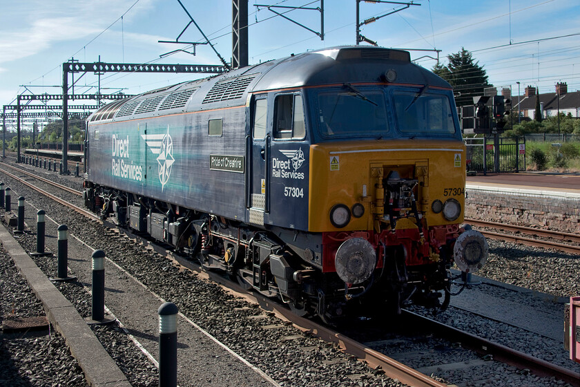 57304, stabled Thunderbird, Rugby station 
 Back in the earlier days of Virgin Trains, the fabled Thunderbirds were scattered at strategic locations up and down the WCML. Wearing their distinctive red liveries and named after the characters from the 1960s British science fiction television series created by Gerry and Sylvia Anderson these converted Class 47s were designed, rather than performing spectacular 2060 rescues in space, to recover failed Virgin Pendolinos and Voyagers. Sadly, they have lost their distinctive identities now that the contract is handled by DRS. Formally named 'Gordon Tracy' 57304 is now named 'Pride of Cheshire' and is seen stabled at Rugby station in the early morning sunshine. 
 Keywords: 57304 stabled Thunderbird Rugby station DRS Direct Rail Services Pride of Cheshire