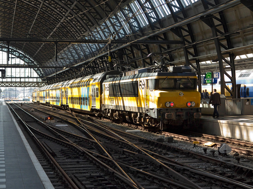 1768, 17.06 Amsterdam Central-Enkhuizen (IC 4554), Amsterdam Central station 
 1768 stands in the dappled lighting under Amsterdam Central's huge 40m wide train shed. It's at the rear end of the IC 4554 17.06 to Enkhuizen. 
 Keywords: 1768 17.06 Amsterdam Central-Enkhuizen IC 4554 Amsterdam Central station