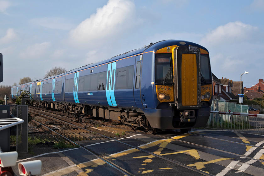 378819, SE 16.50 Ramsgate-London Charing Cross (2W60, 2L), Deal level crossing 
 In absolutely smashing spring lighting, 378819 crossed Deal level crossing forming the 16.50 Ramsgate to London Charing Cross via Dover and Ashford. This level crossing was a busy one, with a large number of vehicles and pedestrians waiting to cross within the few minutes that the barriers were lowered awaiting the passage of this train. After such a dull, cold and damp day, the stunning few hours of weather that we enjoyed during late afternoon was a blessing! 
 Keywords: 378819 2W60 Deal level crossing