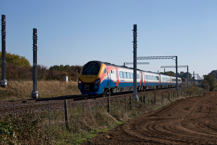 222023, EM 12.47 St. Pancras-Corby (1M36, 1L), Irchester SP927667 
 222023 forms the 12.47 St. Pancras to Corby past Irchester near Wellingborough on the MML. This image shows clearly the electrification process in full swing. Notice also, that the relief line runs slightly higher up on the bank in the background 
 Keywords: 222023 12.47 St. Pancras-Corby 1M36 Irchester SP927667