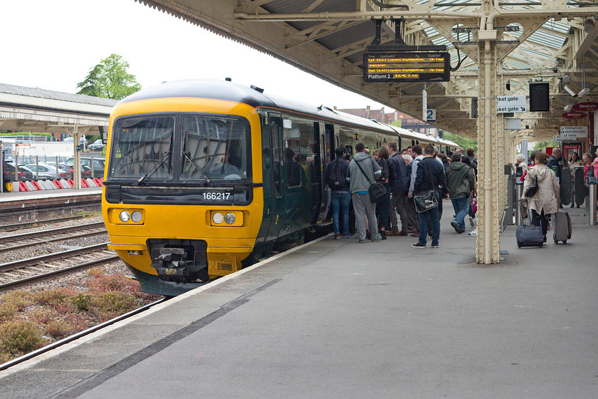 166217, GW 15.40 Bedwyn-London Paddington (1K69), Newbury station 
 A busy scene at Newbury station as the 15.40 Bedwyn to Paddington pauses. These turbos have done a great job on services such as this but their limitations are now clear in terms of peak time capacity. They will be cascaded (the TOC's euphemism for moving them on) soon to other places as the new bi-mode electrics are introduced that will hopefully address the capacity issues. 
 Keywords: 166217 15.40 Bedwyn-London Paddington 1K69 Newbury station