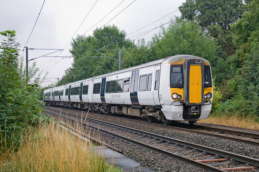 379010, LE 09.58 London Liverpool Street-Cambridge (2H18), Sawston level crossing TL475495 
 379010 heads north past a small occupation level crossing near the village of Sawston in Cambridgeshire. The Greater Anglia Electrostar is working the 09.58 Liverpool Street to Cambridge 2H18 stopper. 
 Keywords: 379010 09.58 London Liverpool Street-Cambridge 2H18 Sawston level crossing TL475495 Abellio Greater Anglia Electrostar