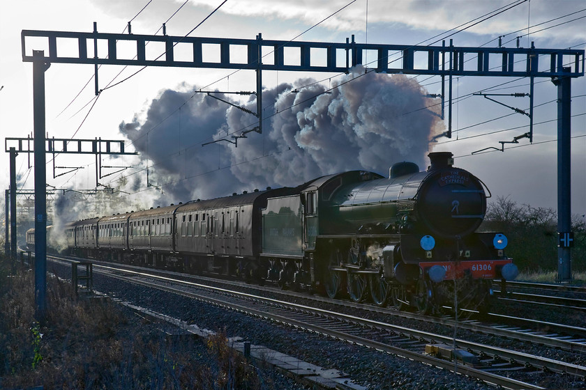 61306 (& 47746), outward leg of The Cathedral's Express, 07.26 London Euston-Chester (1Z89), Ashton Road bridge 
 The low winter sun has really caught the exhaust of 61306 'Mayflower' as it approaches Roade on the down slow line leading the outward leg of The Cathedral's Express charter. The Steam Dreams operated excursion left Euston running as 1Z89 and was heading for Chester so its passengers could enjoy the city's Christmas market. 61306 was substituting for 70000 'Britannia' that was unavailable but being fresh from a comprehensive overhaul, personally I think that 'Mayflower' was the better of the two! Out of sight on the rear of the train was 47746 'Chris Fudge' This was one of those days when everything went to plan with the outward and return workings arriving bang on time. 
 Keywords: 61306 47746 outward leg of The Cathedral's Express, 07.26 London Euston-Chester 1Z89Ashton Road bridge