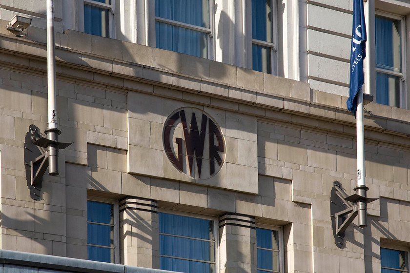 GWR roundel, Hilton Hotel, from Praed Street, Paddington station 
 The GWR roundel as seen here on the front of the former Great Western Hotel (now the Hilton London Paddington) is the later type dating from the period 1934 to 1942. It is colloquially referred to as the 'shirtbutton' monogram and was used throughout the company from buildings such as this to locomotives and letter headings. 
 Keywords: GWR roundel Hilton Hotel from Praed Street Paddington station