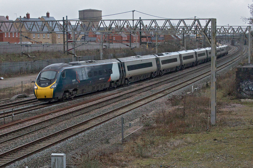 390046, VT 14.51 London Euston-Glasgow Central (1S78, RT), site of Roade station 
 With the down fast line (via Weedon) still shut all services heading north on the WCML are traversing the Northampton route to Hillmarton Junction just south of Rugby. During normal times this would prove chaotic but times are far from normal with the implementation of the emergency COVID induced timetable with services at less than seventy-five per cent of what they should be. 390046 passes Roade working the Avanti West Coast 14.51 Euston to Glasgow service on what is now a very dull and extremely cold afternoon. 
 Keywords: 390046 14.51 London Euston-Glasgow Central 1S78 site of Roade station Avanti West Coast Pendolino