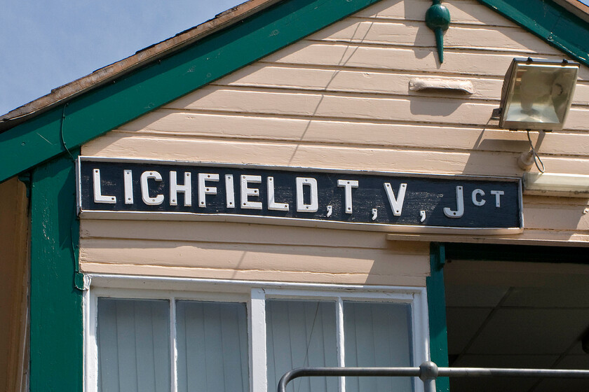 Nameboard, Lichfield TV Junction signal box (LNW, 1897) 
 The nameboard high up on Lichfield Trent Valley signal box is a more modern replacement but not dating from recent times I suspect. Whilst the board itself is timber the letters are plastic resembling the older 1960's style of car number plates and not very professionally placed at that! It's interesting the whoever made the board has used commas instead of the more conventional full stops to separate out the letters of the shortened words. 
 Keywords: Nameboard Lichfield TV Junction signal box