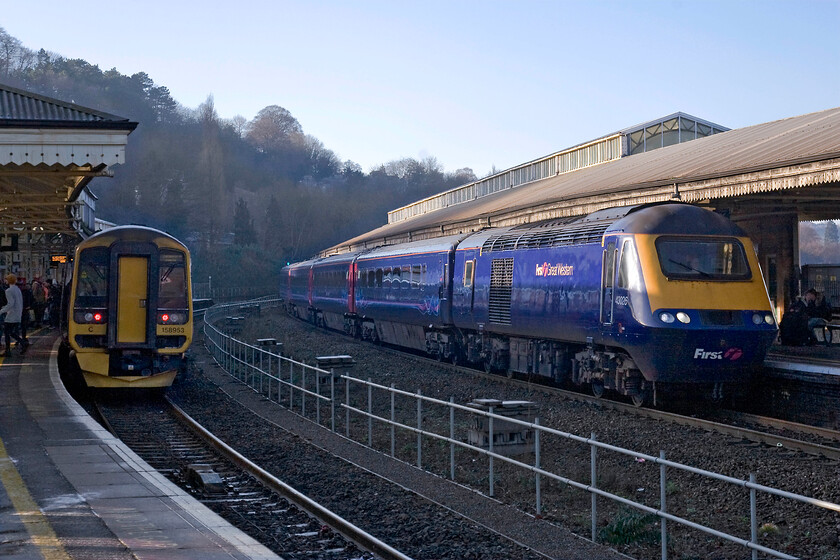 158953, GW 10.23 Portsmouth Harbour-Cardiff Central (Cancelled at Bristol Temple Meads) (1F14) & 43026, GW 08.44 Penzance-London Paddington (1A81), Bath Spa station 
 Whilst 158953 has stopped at Bath Spa's platform one working the 1F14 10.23 Portsmouth Harbour to Cardiff Central (cancelled from Bristol) the 08.44 Penzance to Paddington arrives at platform two. The HST service is being led by 43026 a power car that has been operating on this route since its introduction during the autumn of 1976. If all goes to plan it will reach its fortieth year of operation in 2016 prior to the introduction of the new electric trains whenever that may be given the appalling delays to the electrification process. 
 Keywords: 158953 10.23 Portsmouth Harbour-Cardiff Central Cancelled at Bristol Temple Meads 1F14 43026 08.44 Penzance-London Paddington 1A81 Bath Spa station First Great Western