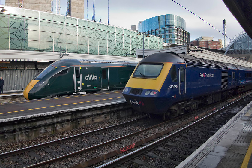 800016, unidentified working & 43030, GW 12.27 London Paddington-Bristol Temple Meads (1C14, 10L), London Paddington station 
 Old and new stand side-by-side at London paddington station. 800016 sits with an unidentified ECS working at platform eleven whilst veteran 43030 'Christian Lewis Trust' makes ready to leave with the 12.27 1C14 to Bristol Temple Meads. Notice the scrap rail in the foreground following on from engineering works. I wonder how long it has been there and equally how long before it will be collected; Network Rail are not great at clearing up after themselves. 
 Keywords: 800016 43030 12.27 London Paddington-Bristol Temple Meads 1C14 London Paddington station